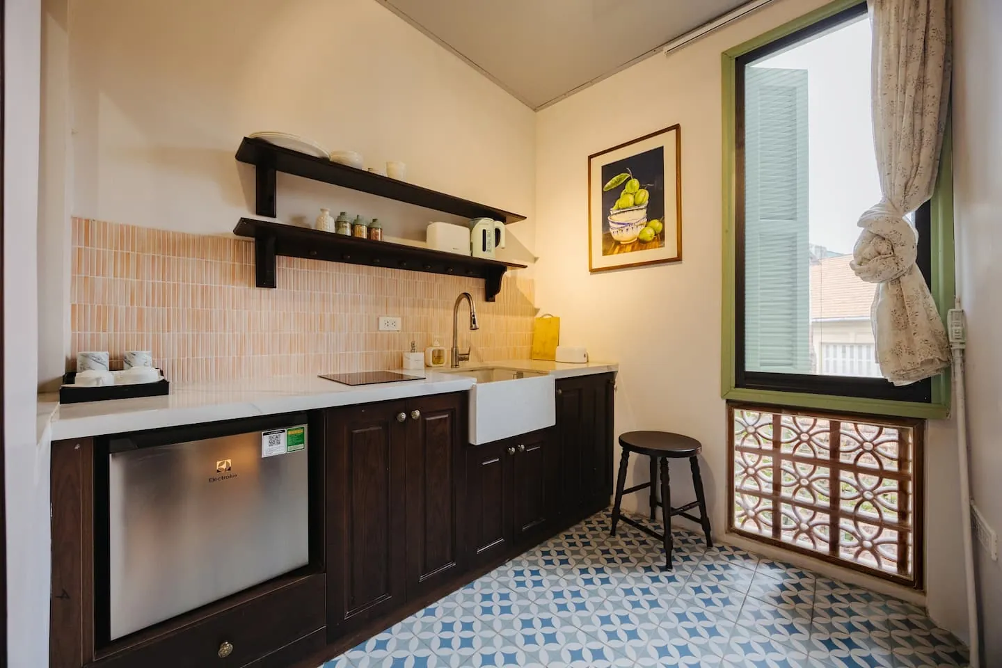 The kitchen of our Xuân loft, with tiled walls and a window onto the street